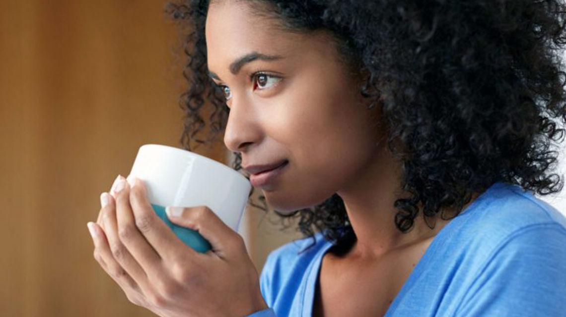 Diverse woman drinking coffee
